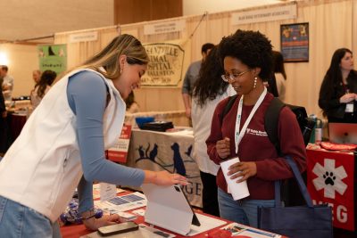 Students and exhibitioners talking at the Veterinary Expo in April 2024.